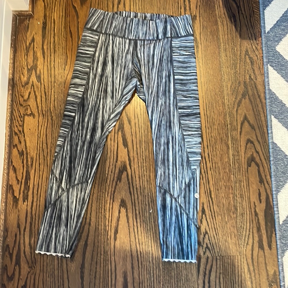 Lululemon leggings with scalloped bottom and blue,black, white stripes pattern